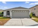 One-story home with attached garage and landscaped yard at 1533 Loch Avich Rd, Winter Garden, FL 34787
