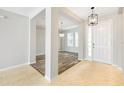 Open foyer featuring tile flooring, modern lighting, and an open view to the dining room at 2781 Sand Oak Loop, Apopka, FL 32712