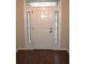 Elegant front door featuring decorative glass side panels and a transom window at 3621 Arlington Ridge Blvd, Leesburg, FL 34748