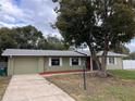 Charming single-story home with a well-manicured lawn, mature shade tree, and a one car garage at 1337 Gaynor Ct, Deltona, FL 32725