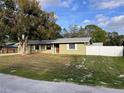 Well-maintained home with tidy front yard, red front door and white picket fence at 1337 Gaynor Ct, Deltona, FL 32725