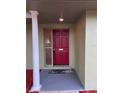 Inviting entryway featuring a red front door, column detail and covered porch at 1337 Gaynor Ct, Deltona, FL 32725