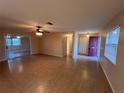 Spacious living room with tile flooring, ceiling fan, and ample natural light at 1337 Gaynor Ct, Deltona, FL 32725