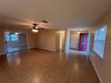 Open-concept living room featuring tile floors, ceiling fan, sliding glass doors, and neutral paint at 1337 Gaynor Ct, Deltona, FL 32725