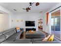 Cozy living room with modern furniture, a ceiling fan, and a sliding glass door to a patio at 2601 Isla Vista Ct, Kissimmee, FL 34747