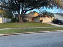 House exterior with driveway and landscaping at 267 Tinder Pl, Casselberry, FL 32707