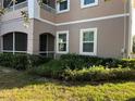Well-maintained exterior with lush landscaping, trimmed bushes, and green grass at 3468 Soho St # 107, Orlando, FL 32835