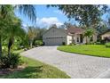 One story house with paver driveway and lush landscaping at 120 Vizcaya Ct, Poinciana, FL 34759