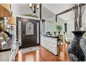 Bright entryway features wood floors, modern décor, and a statement front door at 1407 Edgewater Beach Dr, Lakeland, FL 33805