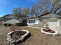 Charming single-story home with a well-maintained lawn and flower beds beneath a clear blue sky at 642 Wheeling Ave, Altamonte Springs, FL 32714