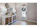 Bright entryway with decorative console table and mirrors at 13219 Woodford St, Orlando, FL 32832