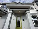 Inviting entrance with a green door, gray trim, and the house number 1344 at 1344 Lumpini St, Saint Cloud, FL 34771