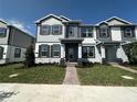 Charming two-story home with a well-manicured lawn and beautiful contrasting trim at 1360 Lumpini St, St Cloud, FL 34771