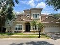 Beautiful two-story home features a two-car garage, elegant entryway, and well-maintained landscaping at 7014 Phillips Cove Ct # 27, Orlando, FL 32819