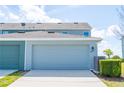 Attached garage showcasing a clean driveway and partial view of the home at 522 Juniper Springs Dr, Groveland, FL 34736