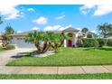 Home's front exterior showcasing a white garage door and lush lawn at 103 Old Sunbeam Dr, South Daytona, FL 32119