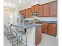 Beautiful Kitchen with granite countertops, stainless steel appliances, and an island with bar seating at 14046 Walcott Ave, Orlando, FL 32827