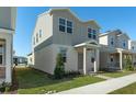 Two-story house with gray siding, a red door and a manicured lawn at 434 Belmond Dr, Debary, FL 32713