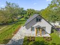 A charming home with a gray exterior, well-manicured lawn, and a stone driveway at 600 N Lakewood Ave, Ocoee, FL 34761