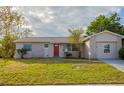 Ranch-style house with stone accents and a red front door at 4533 San Sebastian Cir, Orlando, FL 32808