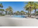 Large community pool surrounded by palm trees and ample seating for residents and guests at 7889 Penrose Pl, Wildwood, FL 34785