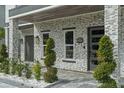 Stylish front porch with stone accents, modern lighting, and meticulously manicured landscaping at 801 W Anderson St, Orlando, FL 32805
