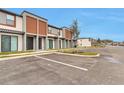 Townhome exterior featuring modern architecture, neat landscaping, and ample parking space at 3245 Sustainable Way, Kissimmee, FL 34747