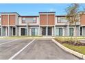 Modern townhome exterior with stylish design, featuring wood accents and a professionally landscaped yard at 3245 Sustainable Way, Kissimmee, FL 34747