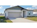 Curb appeal abounds in this one-story home featuring a gray exterior and a landscaped front yard at 2149 Rosewood Dr, Bartow, FL 33830