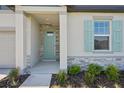 Inviting front entrance with light green door and stone accents at 2149 Rosewood Dr, Bartow, FL 33830