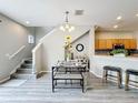 Open-concept dining area boasts stylish furnishings, with a staircase leading to the upper level at 3529 Sanctuary Dr, St Cloud, FL 34769