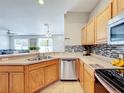 Modern kitchen with stainless steel appliances, a breakfast bar, and plenty of counter space at 3529 Sanctuary Dr, St Cloud, FL 34769
