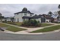 Beautiful two-story home with a two car garage, a lush front lawn, and manicured landscaping at 370 Chicago Woods Cir, Orlando, FL 32824
