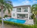 An inviting backyard pool and patio with a luxurious two-story home at 1529 Corolla Ct, Reunion, FL 34747