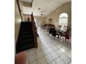 Inviting living room with staircase, tile floors, and abundant natural light at 6776 Brittany Chase Ct, Orlando, FL 32810