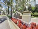 The Grove Resort & Spa sign surrounded by flowers and palm trees offers a warm welcome at 14501 Grove Resort Ave # 1332, Winter Garden, FL 34787