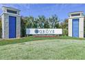 The Grove Resort & Waterpark sign surrounded by flowers, palm trees and a lush green lawn at 14501 Grove Resort Ave # 1332, Winter Garden, FL 34787