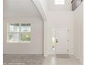 Bright foyer features neutral paint, carpeted living area, and tiled entrance at 5648 Green Arrow Pl, Sanford, FL 32773