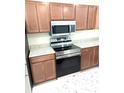 Close-up of kitchen with stainless steel oven, microwave, and granite countertops at 6921 Central Ave, Mulberry, FL 33860