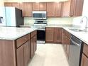 Kitchen featuring stainless steel appliances, granite countertops, and wood cabinets at 6921 Central Ave, Mulberry, FL 33860