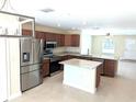 Open kitchen features stainless steel appliances, granite countertops, and a center island at 6921 Central Ave, Mulberry, FL 33860