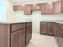 Spacious kitchen featuring granite countertops and wood cabinets at 6921 Central Ave, Mulberry, FL 33860