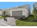 Attached garage with paver driveway and landscaping at 340 Belmond Dr, Debary, FL 32713