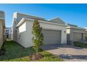 Attached garage with paver driveway and landscaping at 340 Belmond Dr, Debary, FL 32713