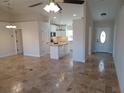 Open-concept view of the home's entryway, living area, and kitchen with ceramic tile flooring at 8749 Se 159Th Ln, Summerfield, FL 34491