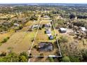 Aerial view of property showing home, outbuildings, and pond at 3330 La Salle Ave, Saint Cloud, FL 34772