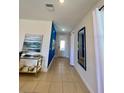 Entryway featuring art, mirror, sleek table, and a blue accent wall, creating a modern and stylish foyer at 7763 Westland Dr, Kissimmee, FL 34747