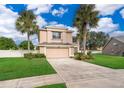 Two-story house with palm trees and a large yard at 14331 Bending Branch Ct, Orlando, FL 32824