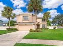 Two-story house with palm trees and a large yard at 14331 Bending Branch Ct, Orlando, FL 32824