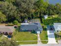 Aerial view showcasing the house, pool, sheds, and landscaped yard in a residential neighborhood at 1533 Findlay St, Deltona, FL 32725